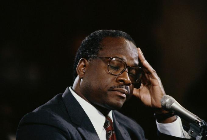 Clarence Thomas închide ochii și își pune mâna la cap în timpul audierii cu privire la presupusa hărțuire sexuală a Anitei Hill.